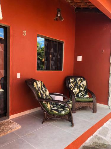 two chairs and a table on a patio at Pousada Encanto dos Anjos in Pirenópolis