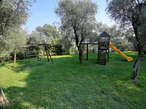 a park with a playground with a slide and trees at VALLE FIORITA 42 - Lake view apartment in Gardone Riviera