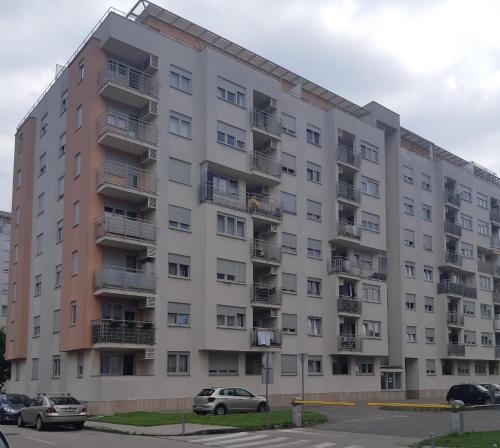 an apartment building with cars parked in front of it at Apartment with garage Lavici in Zagreb
