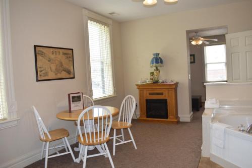 a dining room with a table and four chairs at Hermann Crown Suites in Hermann