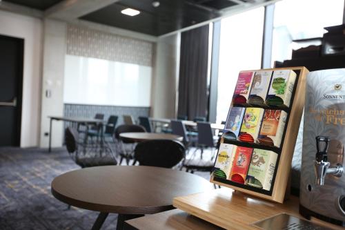 a book rack in a room with tables and chairs at arte Hotel Salzburg in Salzburg
