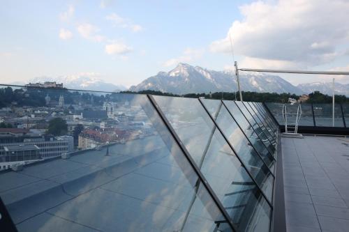 a view from the roof of a building with mountains at arte Hotel Salzburg in Salzburg