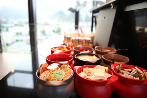 a buffet of food in red bowls on a table at arte Hotel Salzburg in Salzburg