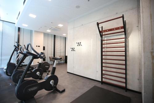 a gym with treadmills and ellipticals in a room at arte Hotel Salzburg in Salzburg