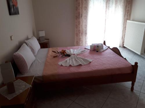a bedroom with a large bed with a pink blanket at POPI 'S HOME in Skala Sotiros