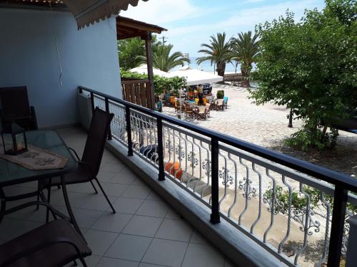 a balcony with a table and chairs and a patio at POPI 'S HOME in Skala Sotiros