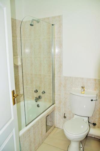 a bathroom with a toilet and a glass shower at Keurbooms River Lodge 21 in Keurboomstrand