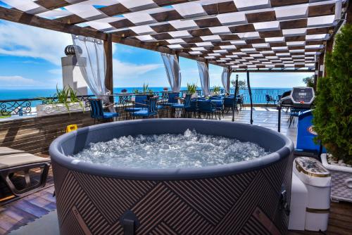 a hot tub on a deck with a view of the ocean at Padam Hotel & SPA in Ulcinj
