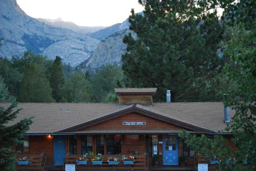 a log cabin with mountains in the background at June Lake Villager in June Lake