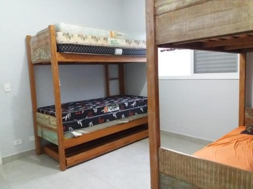 a couple of bunk beds in a room at Morada da Praia - Casa in Bertioga