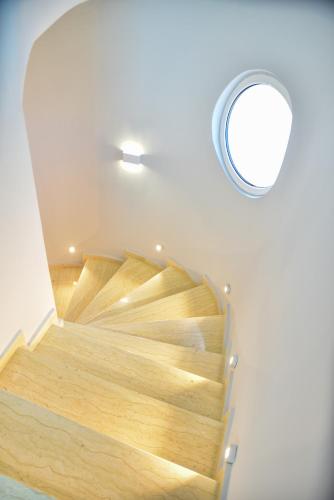 a wooden staircase in a room with a mirror at Padam Hotel & SPA in Ulcinj