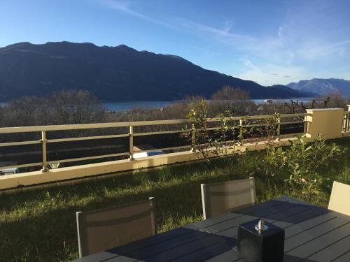 a table and chairs with a view of a lake at Les Terrasses de Tresserve in Aix-les-Bains