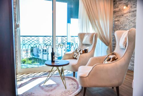 a room with three chairs and a table and a window at Padam Hotel & SPA in Ulcinj