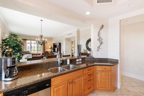 a kitchen with a sink and a living room at Ave Maria Rentals Fl in Immokalee