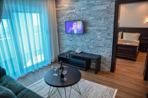 a living room with a couch and a table at Padam Hotel & SPA in Ulcinj