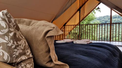 a bed in a room with a balcony at Pálos Resort in Zalacsány