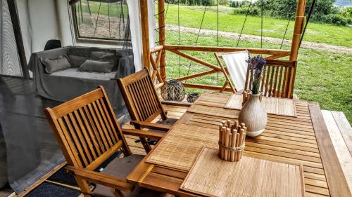 a patio with a table and chairs and a couch at Pálos Resort in Zalacsány