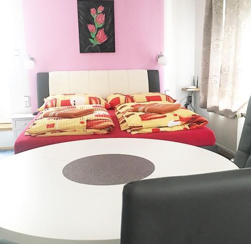 a bedroom with two beds and a white table at Penzion Sv. Duch in Český Krumlov