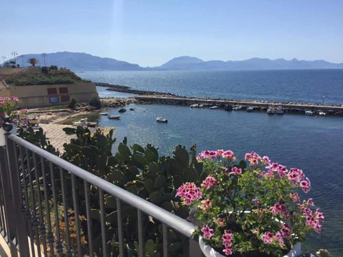 a view of a body of water with flowers on a balcony at Summer Dream LA CASA SUL MARE in Trappeto
