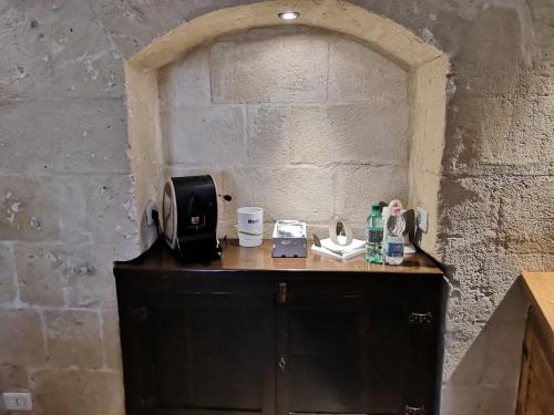a black cabinet with a microwave on top of it at Sassi e Virtù in Matera