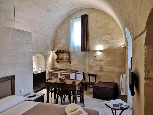 a kitchen and dining room with a table in a room at Sassi e Virtù in Matera