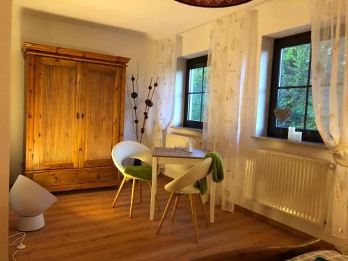a dining room with a table and two chairs at Steinbachblick in Steinbach am Wald