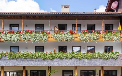 a building with flowers on the balconies at Haus Panorama in Schliersee