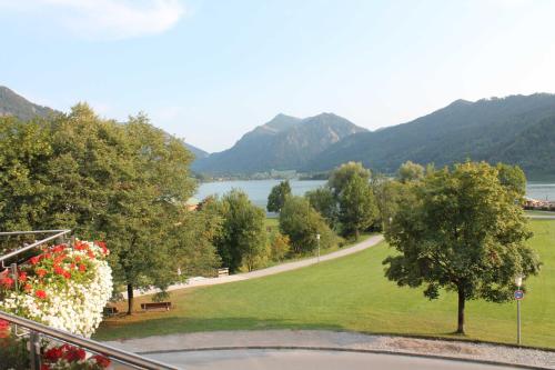 a view of a park with a lake and mountains at Haus Panorama in Schliersee