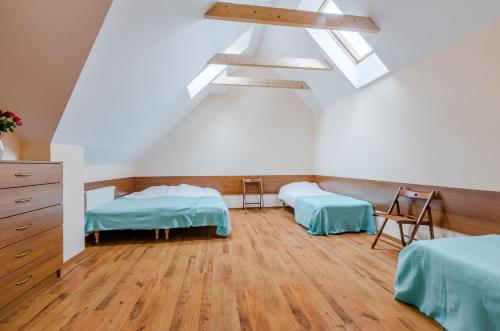 a room with two beds and a dresser at Willa Rowy in Rowy