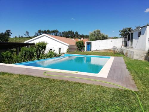 a swimming pool in the yard of a house at Domus Trintorum in Peso da Régua