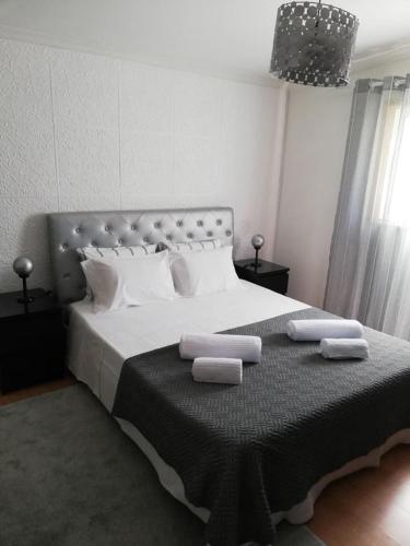 a bedroom with a large bed with two towels on it at Domus Trintorum in Peso da Régua