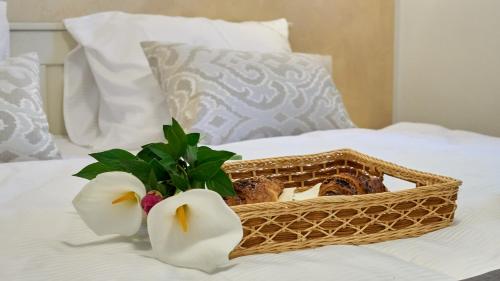 a basket with two flowers on a bed at Casa Valla by Rent Istria in Buzet
