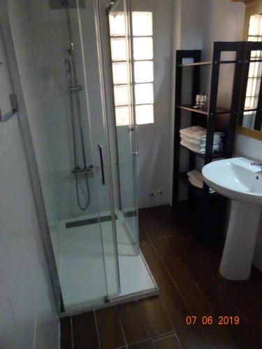 a bathroom with a glass shower and a sink at Hotel Carlos III in Águilas