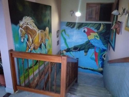 a hallway with a mural of a horse and parrot at Hotel Atenas Jericó in Jericó