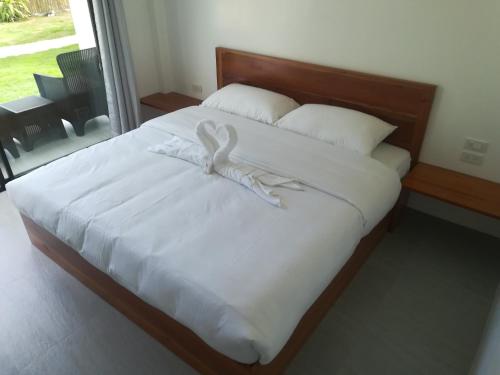 a bed with a white bunny on top of it at Christelle Inn in Panglao
