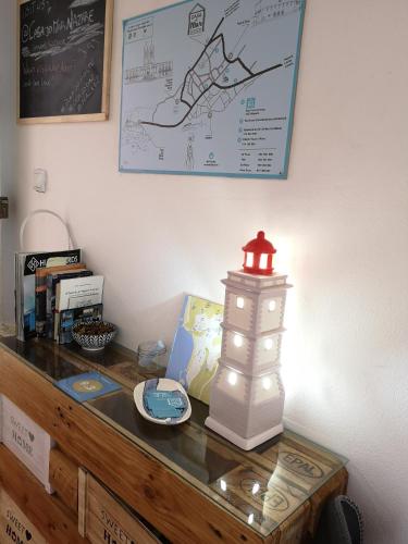 a table with a lighted lighthouse on top of it at Casa do Mar - Nazaré in Nazaré