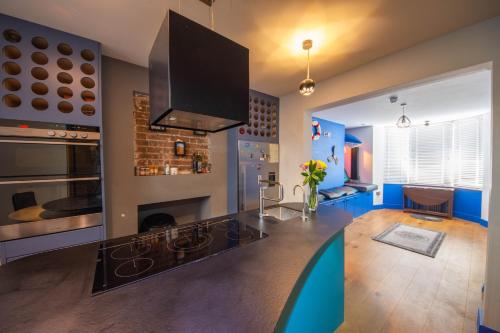 a living room with a glass table and a fireplace at Funky Home by the Pier, 3 Bedrooms, Sleeps 10 in Brighton & Hove