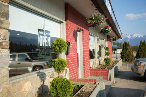 a store with a sign on the side of a building at Valemount Vacation Inn in Valemount