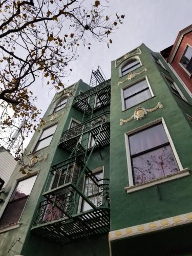 a green building with a clock on the side of it at Perramont Hotel in San Francisco