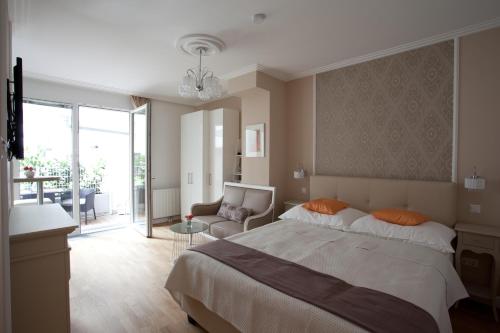 a bedroom with a bed and a living room at Sofie Apartments in Vienna