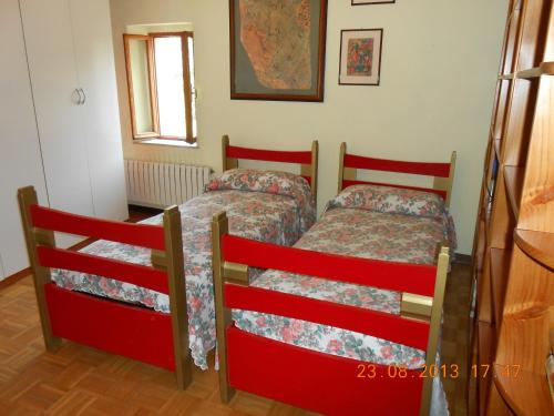 a bedroom with two beds and a window at B&B La Pilastrina in Maranello