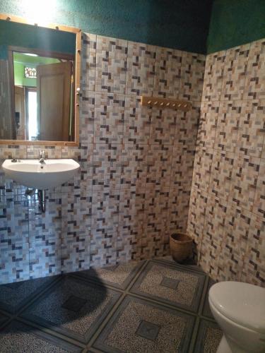 a bathroom with a sink and a toilet at Dinoyin Bungalows in Gili Meno