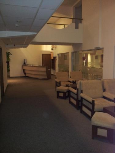 a waiting room with couches and chairs in a building at Hostel Elena in Sofia