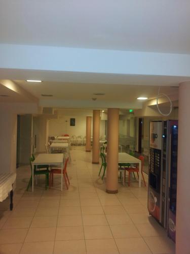 an empty cafeteria with tables and chairs and machines at Hostel Elena in Sofia