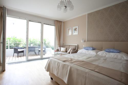 a bedroom with a bed and a living room at Sofie Apartments in Vienna
