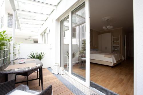 a balcony with a bedroom and a bed in a room at Sofie Apartments in Vienna
