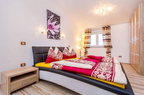 a bedroom with a large bed with red pillows at Villa Marcelia in Pula
