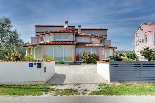 a large house with a fence in front of it at Villa Marcelia in Pula