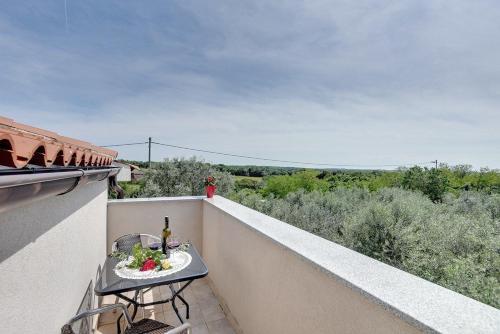 a table on the balcony of a building with a view at Villa Marcelia in Pula