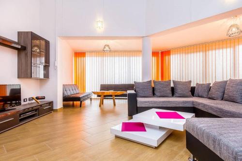 a living room with a couch and a tv at Villa Marcelia in Pula